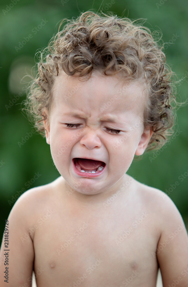 Sad baby with curly hair crying Sad baby with curly hair crying