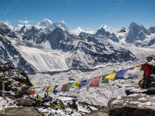 Snowy view of the himalayas and Mount Everest from Gokyo Ri with prayer flags on a clear day