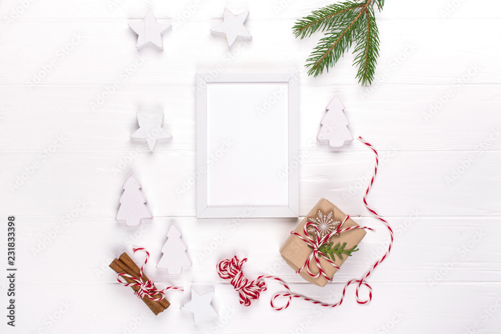 Christmas mock up with photo frame, eco gift boxes and tree branches. New year celebration, holiday concept. Flat lay, top view, copy space Christmas mock up with photo frame, eco gift boxes and tree branches. New year celebration, holiday concept. Flat lay, top view, copy space