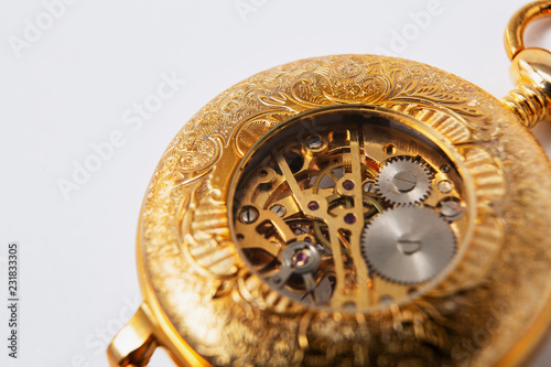 the inside of a classic watch gear wheels of a pocket watch