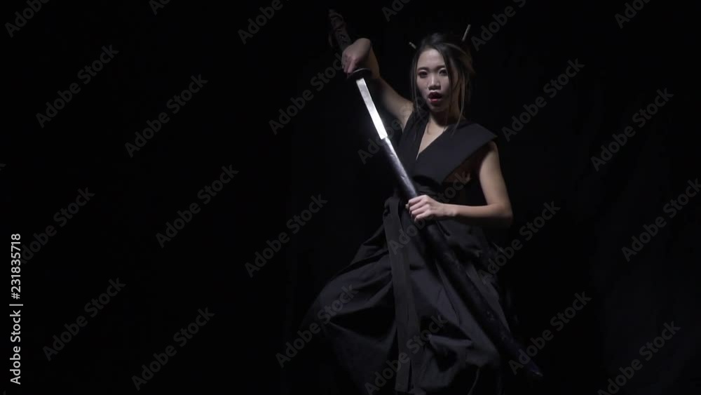 Japanese woman pulls out the katana with a scream Japanese woman pulls out the katana with a scream