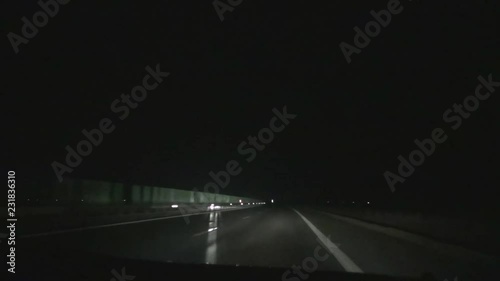 Car Driving in Night on the a Highway with Big Speed and Headlights On 