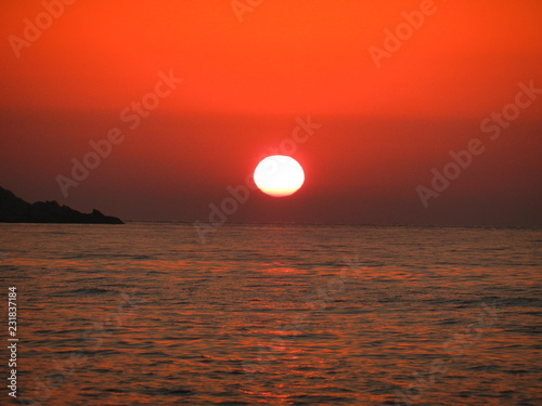 Fototapeta Naklejka Na Ścianę i Meble -  fire sky at sunset in Gialiskari, Ikaria island, North Aegean, Greece