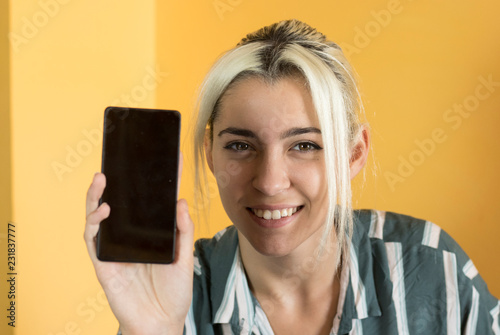 Office worker showing a mockup of the phone screen photo