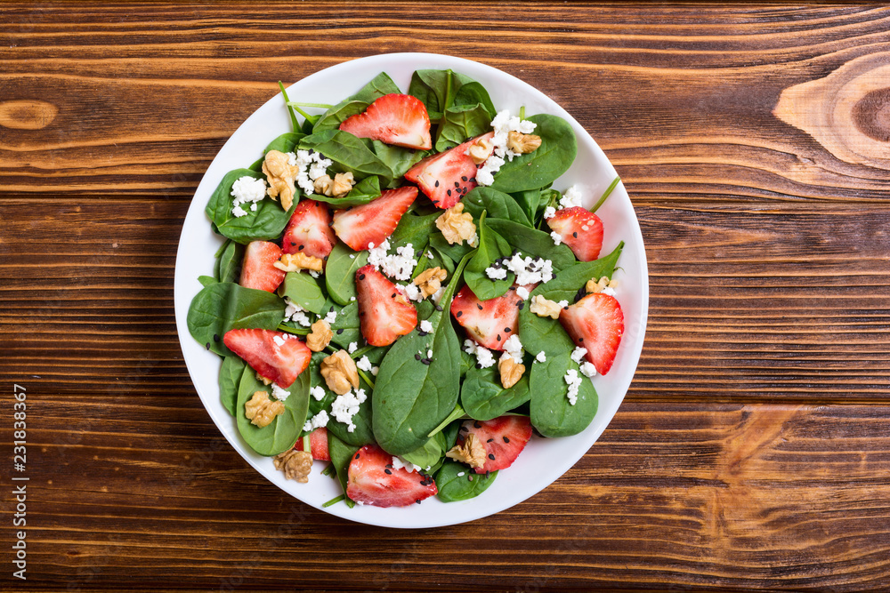 Strawberry salad with spinach , cheese and walnut