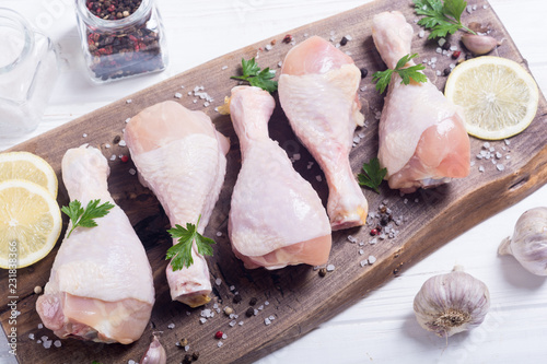 Raw chicken legs with spices and parsley