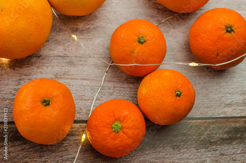 tangerines, peeled tangerine and tangerine slices on a white wooden table