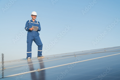 operation and maintenance in solar power plant ; engineering team working on checking and maintenance in solar power plant ,solar power plant to innovation of green energy for life