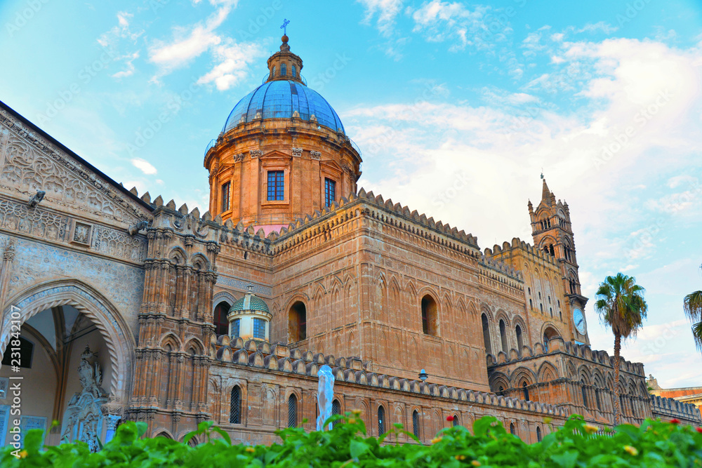 The dome of Palermo Cathedral gothic church against warm sunset cloudy blue sky, Sicily, Italy