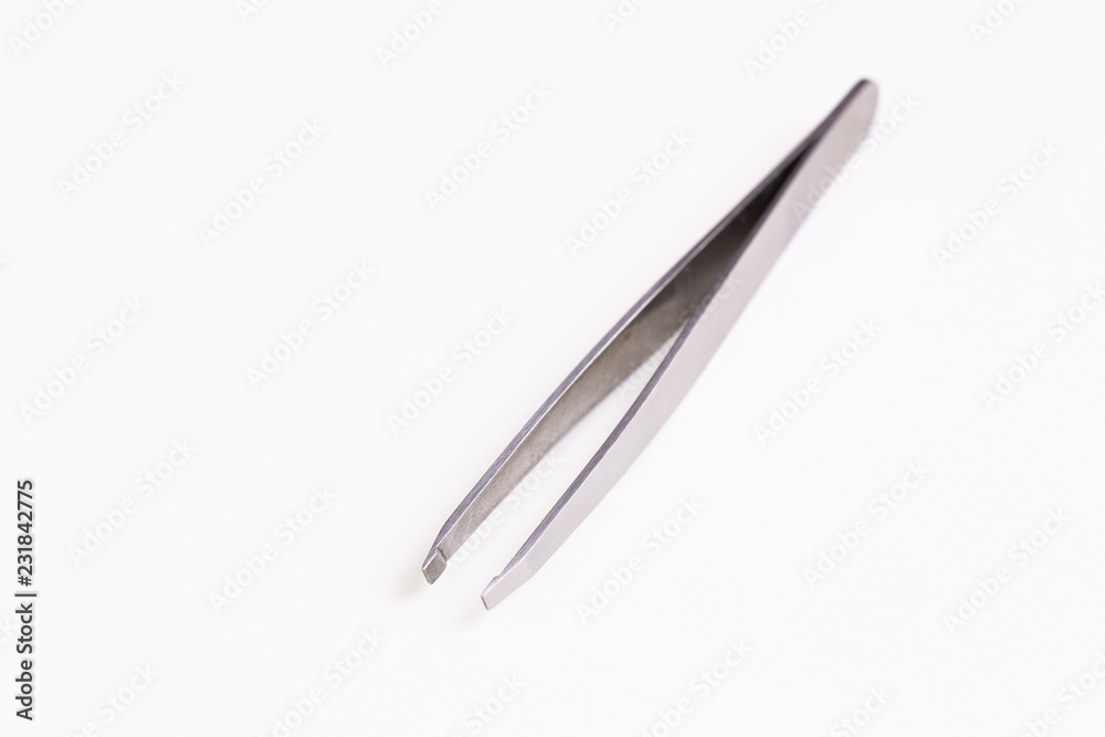 Metal tweezer on white background Metal tweezer on white background