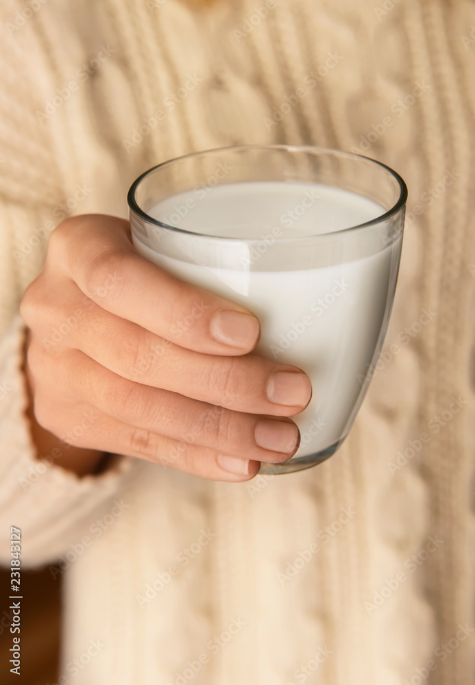 Woman holding glass of delicious milk, closeup Woman holding glass of delicious milk, closeup