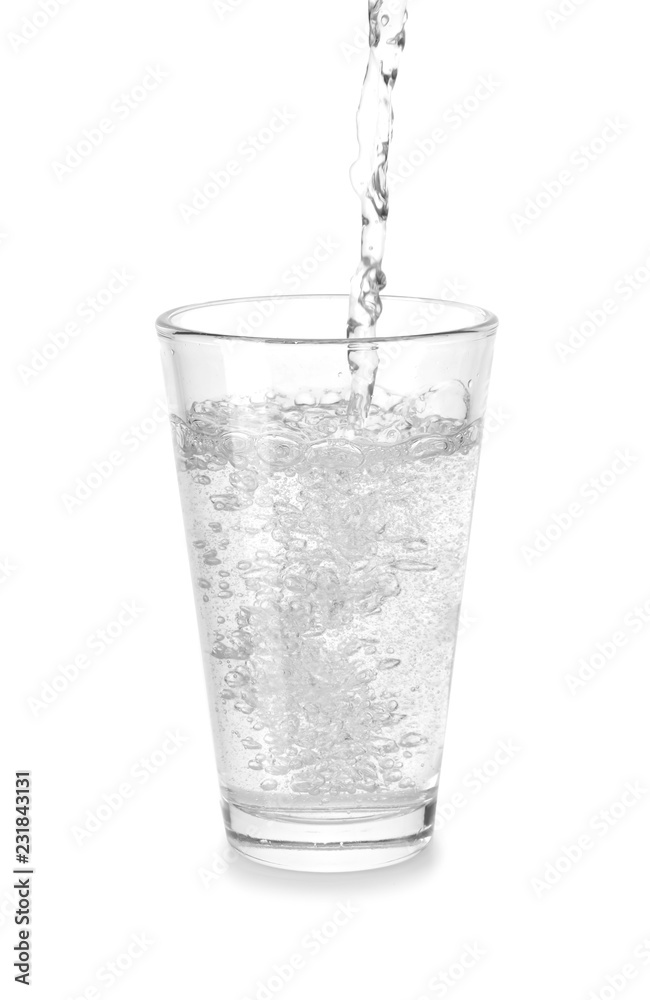 Pouring of mineral water in glass on white background Pouring of mineral water in glass on white background