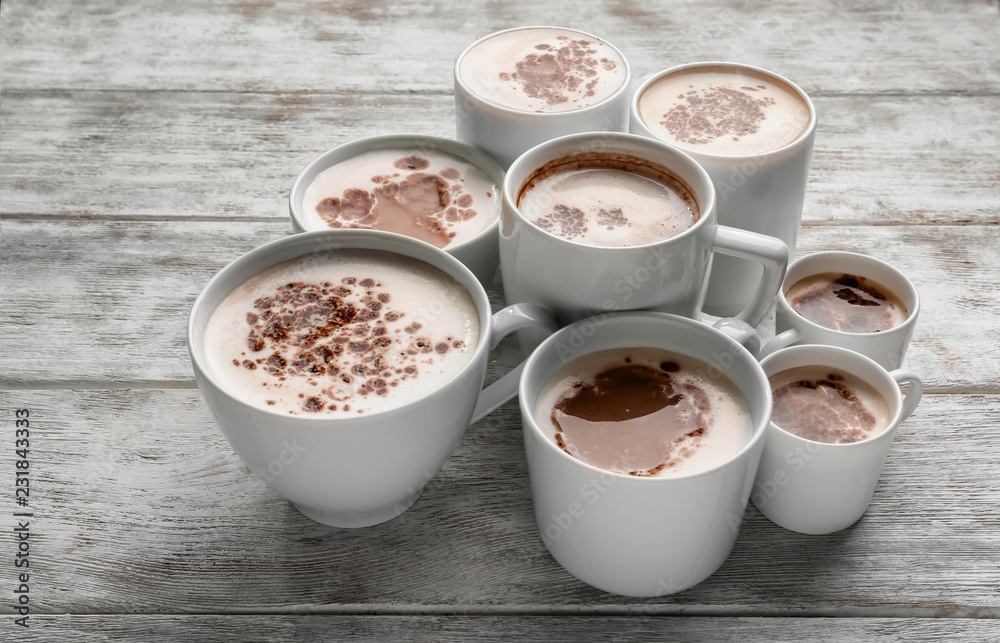 Many cups with tasty aromatic coffee on wooden table Many cups with tasty aromatic coffee on wooden table