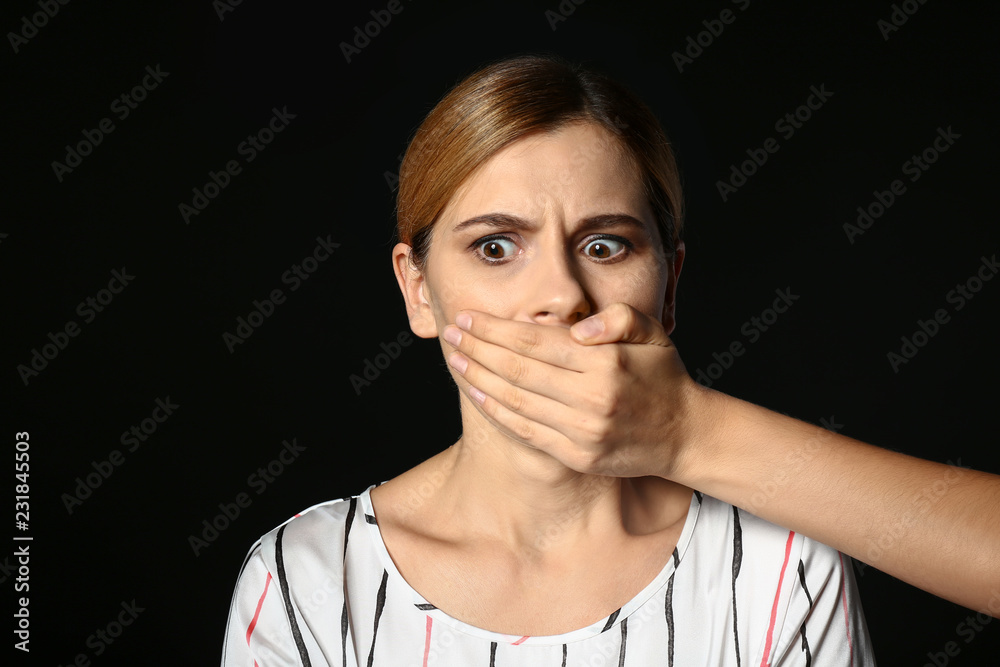 Hand covering mouth of woman on dark background. Panic attack Hand covering mouth of woman on dark background. Panic attack