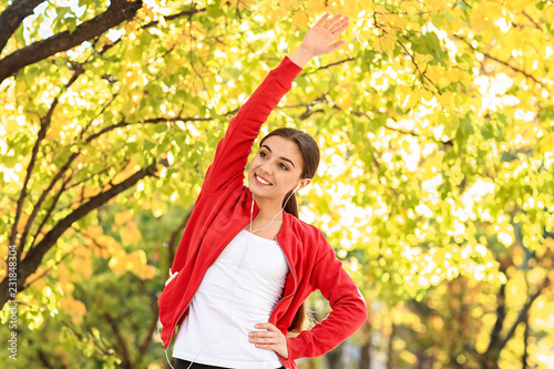Sporty woman training in park on autumn day