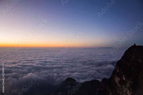 Beautiful sea of clouds during sunrise. A monastery stands alone at Emei-Shan  Sichuan province  China