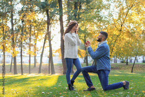 Young man proposing to his ...