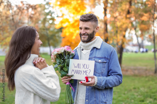 Young man proposing to his ...
