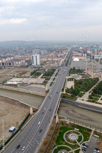 Grozny, Russia: 10.07.2015. Daily life in Chechen Republic. Aerieal view of the Lenin bridge over the Sunzha river and Vladimir Putin Avenue photo