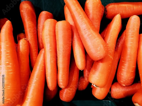 Orange carot on black ground.