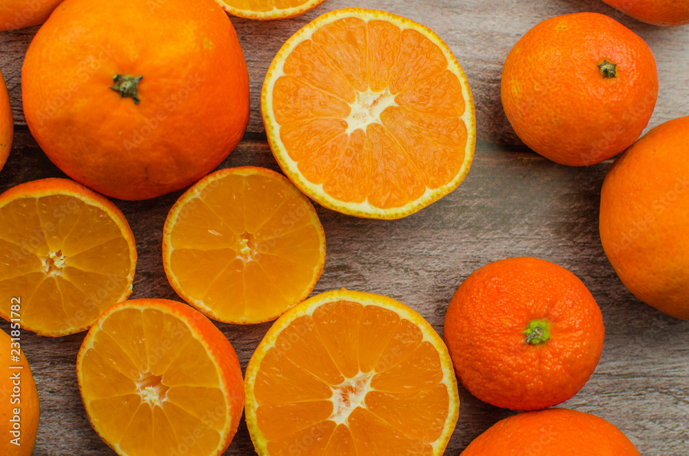 tangerines, peeled tangerine and tangerine slices on a white wooden table tangerines, peeled tangerine and tangerine slices on a white wooden table