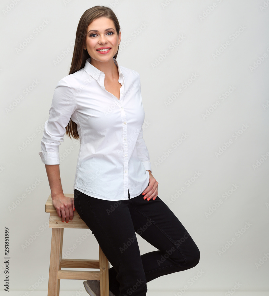 Smiling woman in white shirt sitting on barstool. Smiling woman in white shirt sitting on barstool.