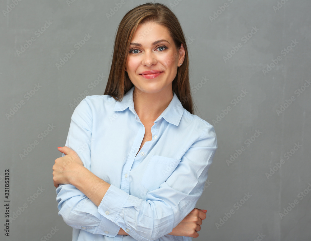 Close up portrait of smiling woman with arms. Grey wall background. Close up portrait of smiling woman with arms. Grey wall background.