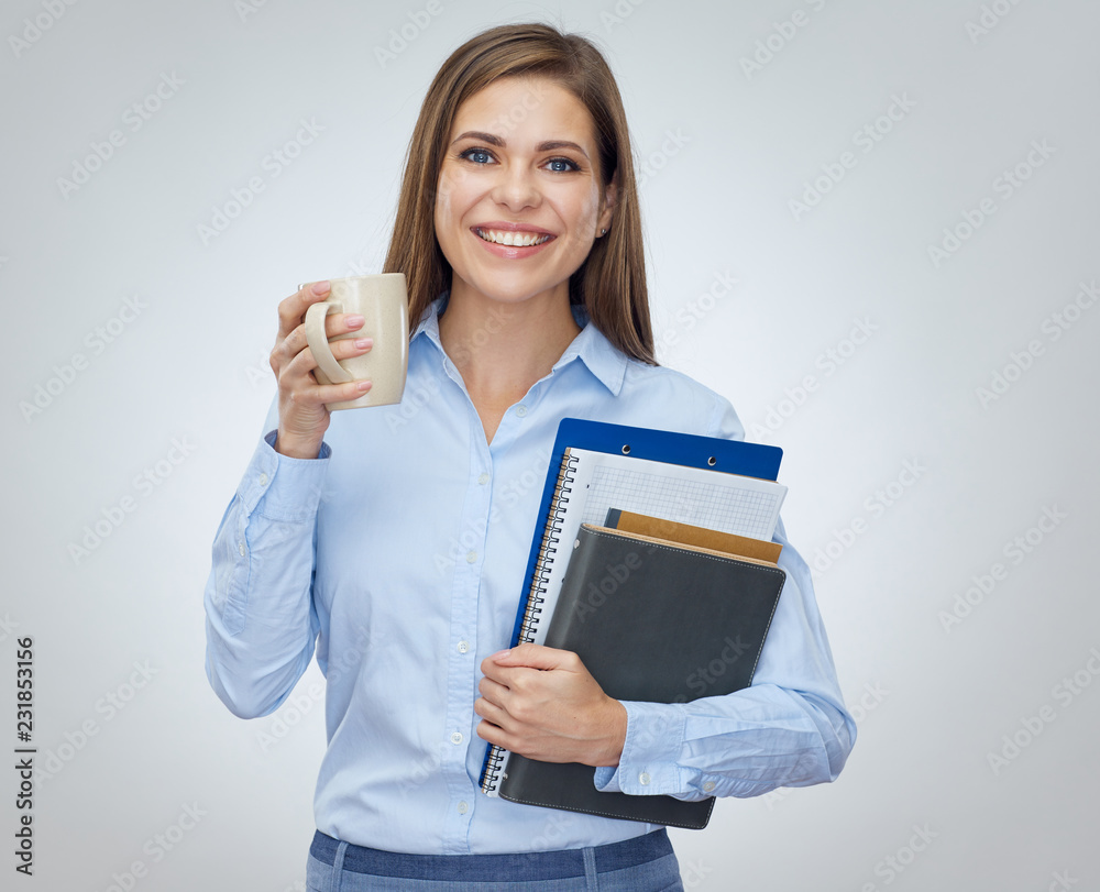 Smiling business woman holding cup and books. Smiling business woman holding cup and books.