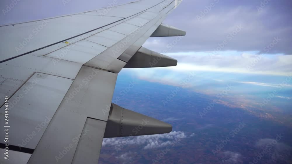 Airplane wing view from the porthole clouds Airplane wing view from the porthole clouds