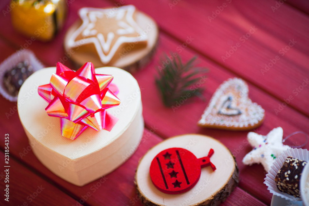 Cup of chocolate with marshmallow, gingerbread cookies, gifts and beautiful Christmas decorations on the wooden background. Flat lay, top view, space for a text. Cup of chocolate with marshmallow, gingerbread cookies, gifts and beautiful Christmas decorations on the wooden background. Flat lay, top view, space for a text.
