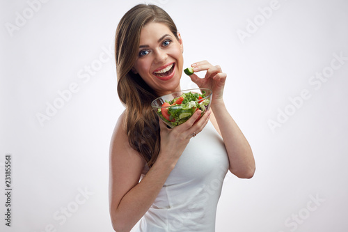 Smiling woman eating salad. Beautiful girl with healthy food.