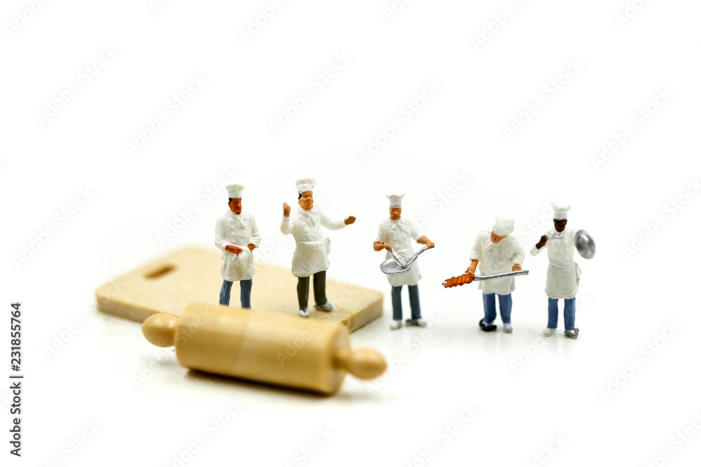 Miniature people : Chef during cooking and working on white background.