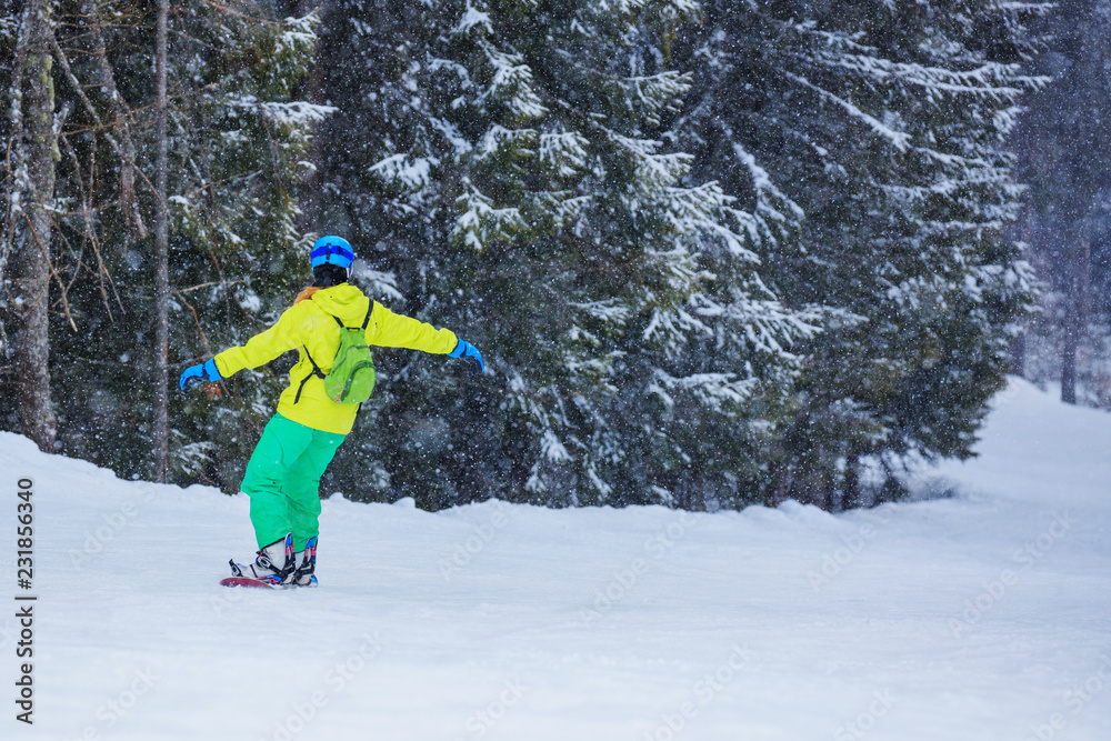 Girl snowboarder enjoys the winter ski resort.