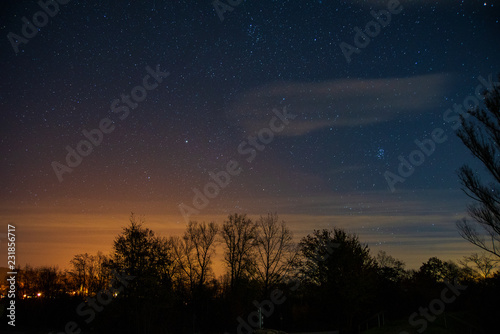 View of the stars aldebaran,hyadun I and hyadun II in the constellation of taurus over the eastern sky in Southern Germany with light pollution from a nearby village photo