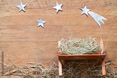 Manger and star of Bethlehem abstracy christmas background nativity scene on wooden board
 photo