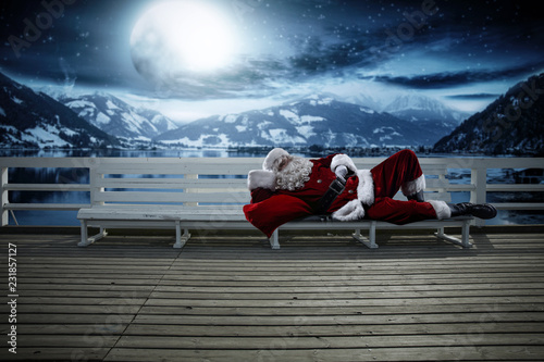 Santa Claus on wooden pier and winter night. Free space for your decoration.  © magdal3na