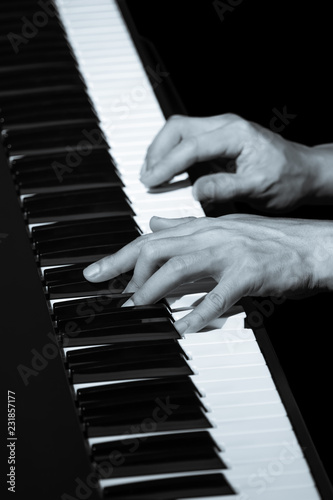 male musician hands playing on piano keys
