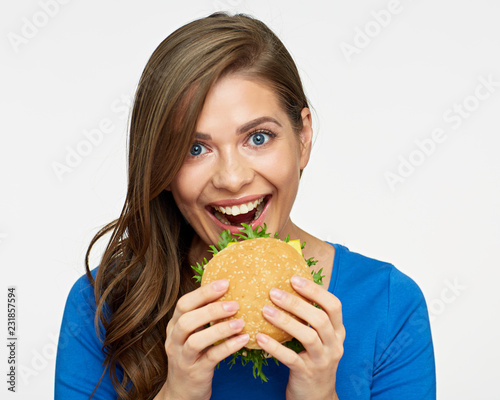 Smiling woman eat fast food burger.