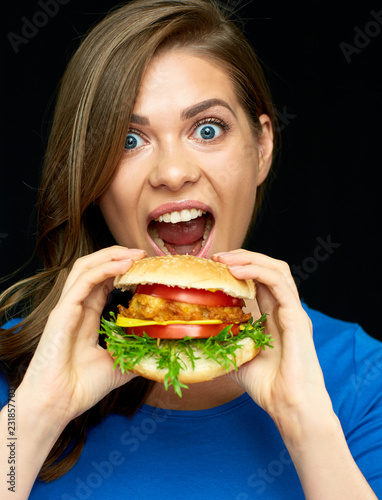 Woman eating cheeseburger  isolated portrait