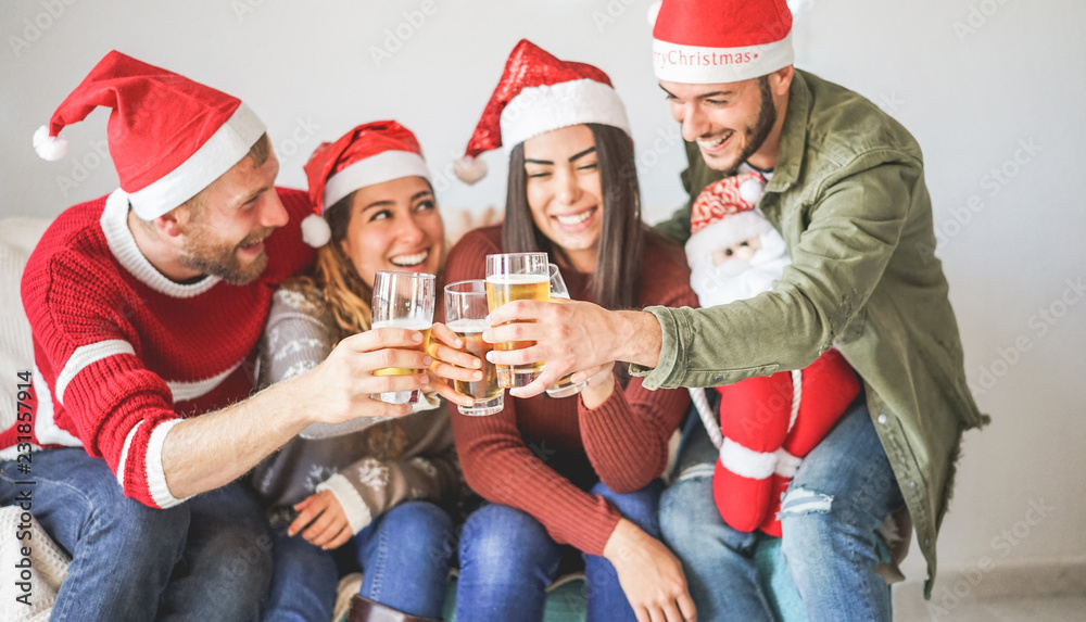 Group of friends cheering with beer at christmas party Group of friends cheering with beer at christmas party