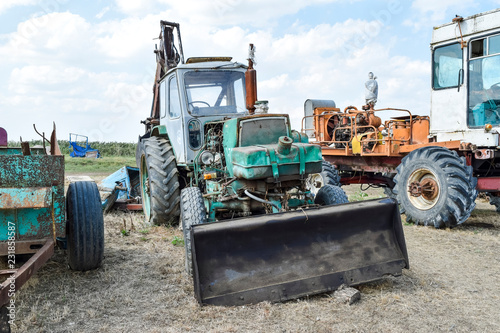 Russia  Temryuk - 15 July 2015  Tractor. Bulldozer and grader. Tractor with a bucket for digging soil. The picture was taken at a parking lot of tractors in a rural garage on the outskirts of Temryuk.