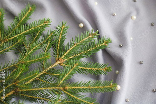 green branches of spruce with a cozy warm knitted scarf, place for text. rustic christmas tree and woolen clothes. Hygienic winter view.. photo