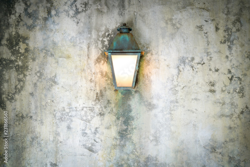 Rough cement wall texture background with a lamp © alice_photo