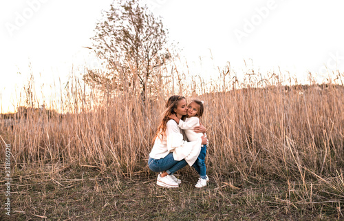 Mum and daughter having fun together outdoors.