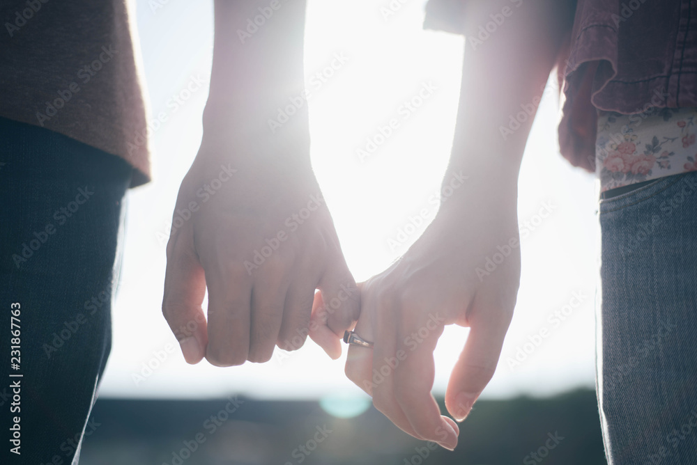 Woman & man hook little finger for holding hands Stock Photo