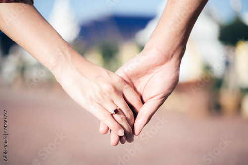 Woman & man holding hand