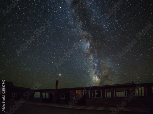 Fototapeta Naklejka Na Ścianę i Meble -  Bright stars of the Milky Way on the night sky above the empty roadside cafe. North Caucasus in Russia.