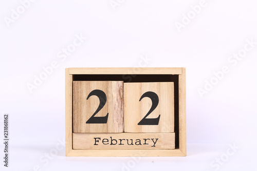 Wooden cubes calendar with the date of February 22. Concept calendar for year with copy space isolated on white background