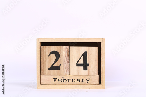 Wooden cubes calendar with the date of February 24. Concept calendar for year with copy space isolated on white background
