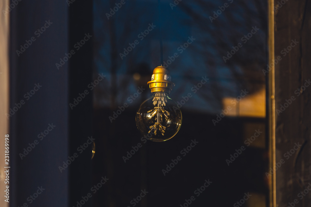 Obraz premium old light bulb glows in the dark close up